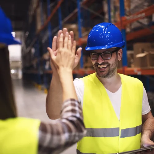 warehouse-worker-giving-high-five-his-friend-colleague